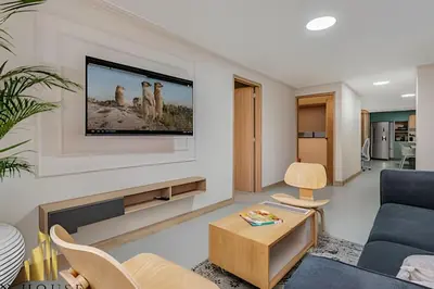 a living room with a tv on a wall at Paola 201 - Charm and perfect location in Laureles in Guayaquil