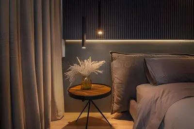 a bedroom with a bed and a table with a vase on it at Parma 2305 - Elegance in the Urban Heart / Poblado in El Poblado