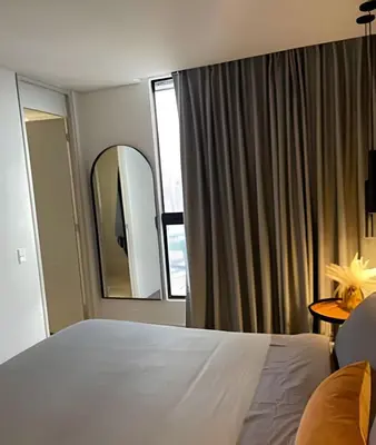 a bedroom with a large bed and a mirror at Parma 2305 - Elegance in the Urban Heart / Poblado in El Poblado