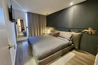 a bedroom with a bed and a mirror at Parma 2305 - Elegance in the Urban Heart / Poblado in El Poblado