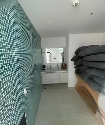 a bedroom with a green tile wall and a bed at Parma 2305 - Elegance in the Urban Heart / Poblado in El Poblado