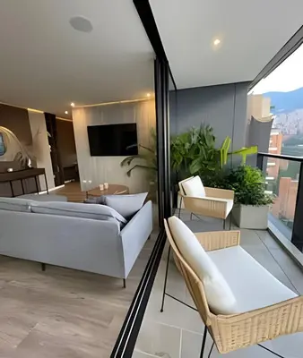a living room with a white couch and chairs at Parma 2305 - Elegance in the Urban Heart / Poblado in El Poblado