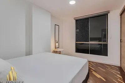 a bedroom with a white bed and a large window at Poblado Del Campestre 203 - Comfort & Exclusivity in Envigado