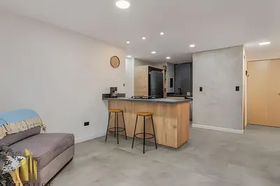 a kitchen and living room with a counter and a couch at Poblado Del Campestre 203 - Comfort & Exclusivity in Envigado