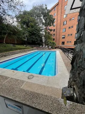 a swimming pool in front of a building at Poblado Del Campestre 203 - Comfort & Exclusivity in Envigado