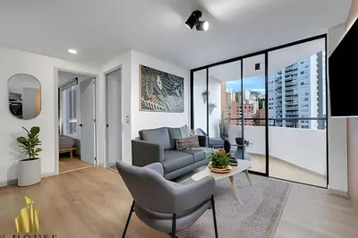 a living room with a couch and a table at Poblado Sandiego 1505 - Cool off in style apt/pool in El Salvador