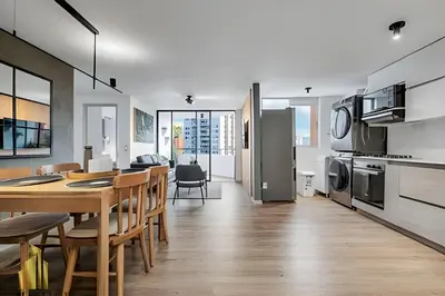 a kitchen and dining room with a table and chairs at Poblado Sandiego 1505 - Cool off in style apt/pool in El Salvador
