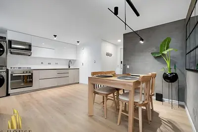 a kitchen with a wooden table and chairs in a room at Poblado Sandiego 1505 - Cool off in style apt/pool in El Salvador
