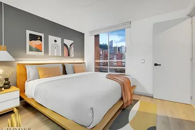 a bedroom with a large bed and a large window at Poblado Sandiego 1505 - Cool off in style apt/pool in El Salvador