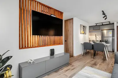 a living room with a large television on a wall at Portal de los Parra 1604 - Peaceful apt/Balcony in El Poblado
