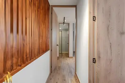 a hallway of a house with wooden walls and a mirror at Portal de los Parra 1604 - Peaceful apt/Balcony in El Poblado