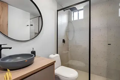 a bathroom with a sink and a glass shower at Portal de los Parra 1604 - Peaceful apt/Balcony in El Poblado