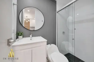 a white bathroom with a sink and a mirror at Provenza Life 1001 - Airy apt w priv balcony & gym in El Poblado