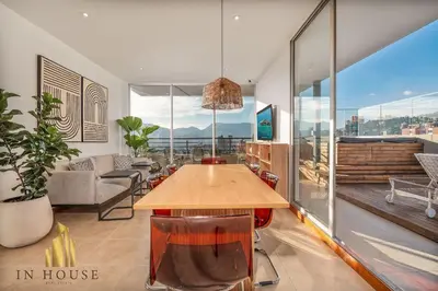 a dining room with a table and a large window at Provenza Life 1001 - Airy apt w priv balcony & gym in El Poblado
