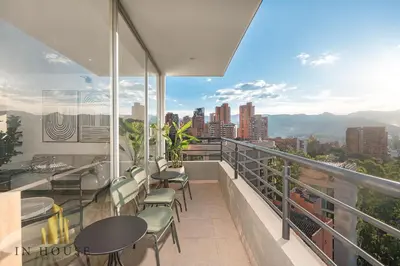 a balcony with chairs and tables and a view of the city at Provenza Life 1001 - Airy apt w priv balcony & gym in El Poblado