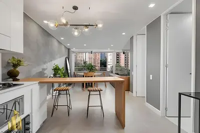 a kitchen with a wooden counter and stools at Provenza Life 1001 - Airy apt w priv balcony & gym in El Poblado