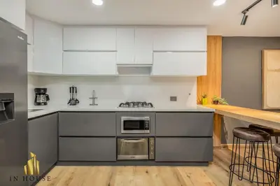 a kitchen with stainless steel appliances and white cabinets at Provenza Life 1002-Tastefully decorated loft/gym in El Poblado