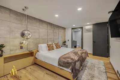 a bedroom with a large bed and a wall at Provenza Life 1002-Tastefully decorated loft/gym in El Poblado