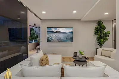 a living room with white furniture and a tv at Provenza Life 1002-Tastefully decorated loft/gym in El Poblado