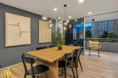 a dining room with a wooden table and chairs at Provenza Life 1002-Tastefully decorated loft/gym in El Poblado