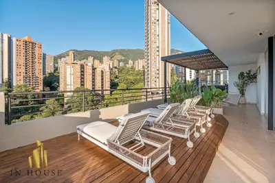 a group of white chairs on a balcony with a view at Provenza Life 1002-Tastefully decorated loft/gym in El Poblado