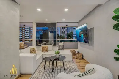 a living room with white furniture and a large window at Provenza Life 1002-Tastefully decorated loft/gym in El Poblado
