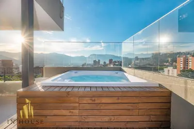 a hot tub on top of a building with a view at Provenza Life 1003 - Airy Loft with abundant light in El Poblado