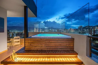 a hot tub in a balcony with a view of the city at Provenza Life 1003 - Airy Loft with abundant light in El Poblado