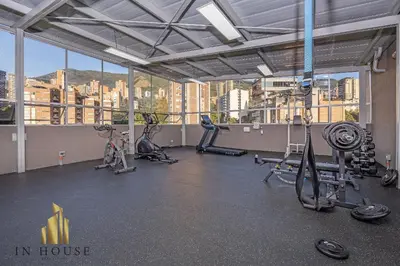 a gym with cardio equipment in a large room with windows at Provenza Life 1003 - Airy Loft with abundant light in El Poblado
