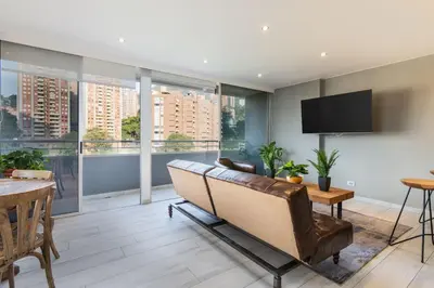 a living room with a couch and a table at Provenza Life 1003 - Airy Loft with abundant light in El Poblado