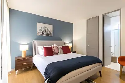 a bedroom with a large bed with red pillows at Provenza Life 501 - Apt in the heart of Provenza in El Poblado