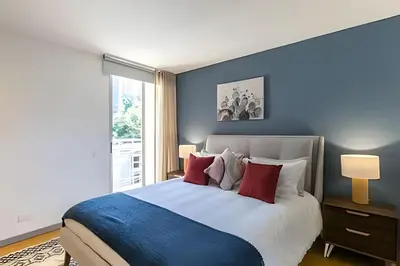 a bedroom with a large bed with red pillows at Provenza Life 501 - Apt in the heart of Provenza in El Poblado