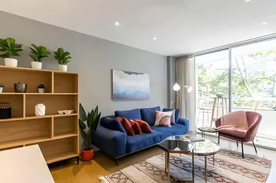 a living room with a blue couch and chairs at Provenza Life 501 - Apt in the heart of Provenza in El Poblado