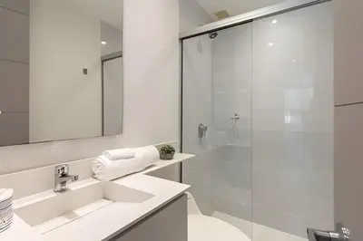 a white bathroom with a sink and a shower at Provenza Life 501 - Apt in the heart of Provenza in El Poblado