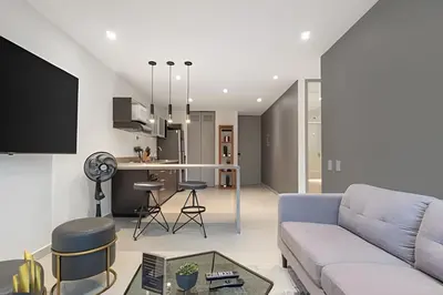 a living room with a couch and a kitchen at Provenza Life 703 - Secure/bright apt/priv balcony in El Poblado