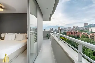 a balcony with a bed and a view of the city at Provenza Life 703 - Secure/bright apt/priv balcony in El Poblado
