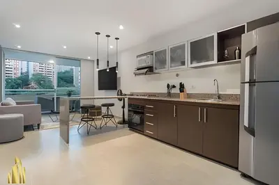 an open kitchen and living room with a couch at Provenza Life 703 - Secure/bright apt/priv balcony in El Poblado