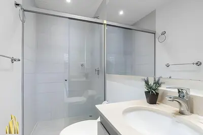 a bathroom with a glass shower and two sinks at Provenza Life 703 - Secure/bright apt/priv balcony in El Poblado