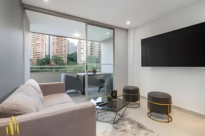 a living room with a couch and a flat screen tv at Provenza Life 703 - Secure/bright apt/priv balcony in El Poblado