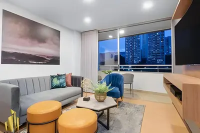 a living room with a couch and a large window at Provenza Life 901 - Serene/family-friendly loft in El Poblado