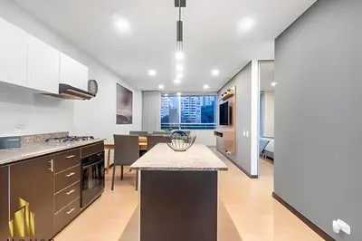a kitchen with a island in the middle of a room at Provenza Life 901 - Serene/family-friendly loft in El Poblado