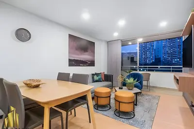 a living room with a table and a couch at Provenza Life 901 - Serene/family-friendly loft in El Poblado