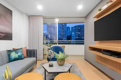 a living room with a couch and a large window at Provenza Life 901 - Serene/family-friendly loft in El Poblado
