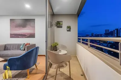 a bedroom with a balcony with a view of the city at Provenza Life 901 - Serene/family-friendly loft in El Poblado
