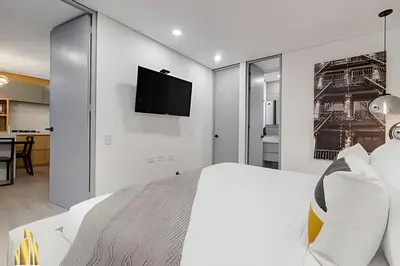 a bedroom with a bed and a tv on the wall at Provenza Life 903 - Modern/cozy living in Provenza in El Poblado