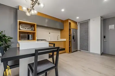 a kitchen with a black and white counter and a table at Provenza Life 903 - Modern/cozy living in Provenza in El Poblado