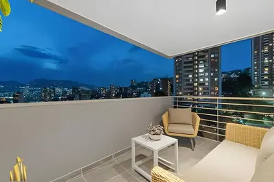 a balcony with a view of the city at night at Provenza Life 903 - Modern/cozy living in Provenza in El Poblado