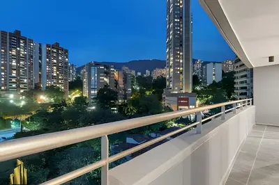 a balcony with a view of the city at night at Provenza Life 903 - Modern/cozy living in Provenza in El Poblado