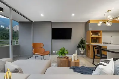 a living room with a couch and a tv on a wall at Provenza Life 903 - Modern/cozy living in Provenza in El Poblado