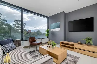 a living room with a couch and a tv at Q Tower 506 - Bright & Chic Loft In Poblado in Las Palmas